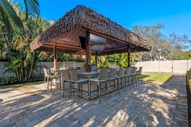 view of patio / terrace featuring a gazebo and a bar