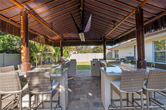 view of patio with an outdoor bar, a grill, exterior kitchen, and a gazebo