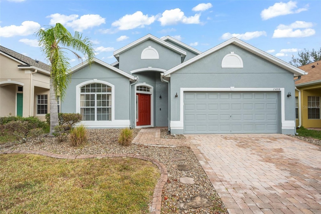 single story home with a front lawn and a garage