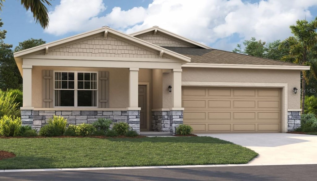 view of front of property with a front yard and a garage