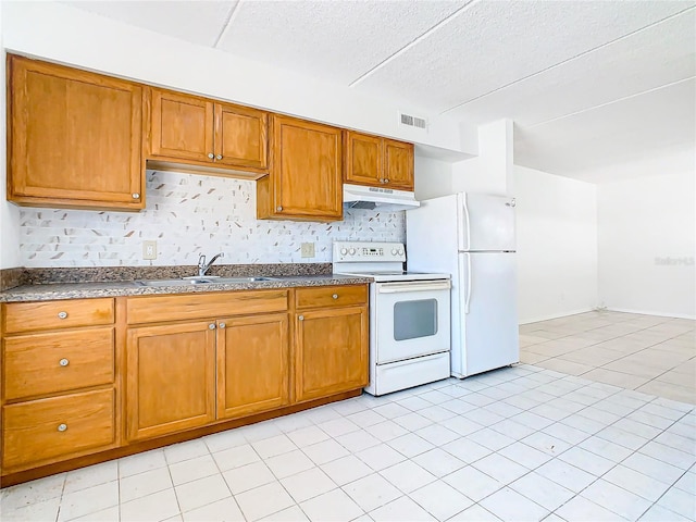 kitchen featuring light tile patterned floors, sink, backsplash, and white appliances