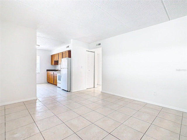 unfurnished living room with light tile patterned floors