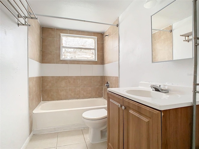 full bathroom with toilet, vanity, tiled shower / bath, and tile patterned flooring