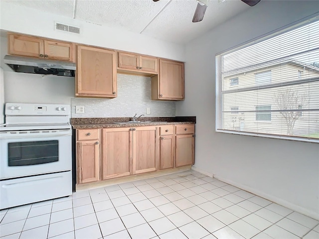 kitchen with electric stove, light tile patterned floors, plenty of natural light, and sink