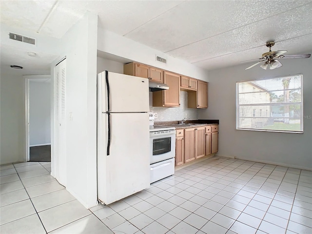 kitchen featuring white appliances, light brown cabinets, sink, ceiling fan, and light tile patterned floors