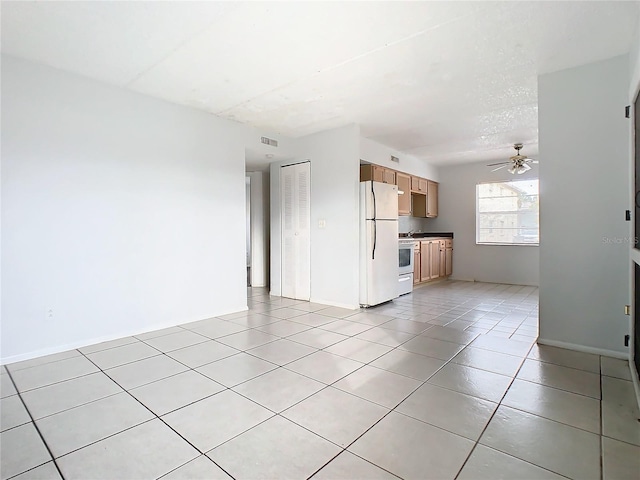 unfurnished living room with ceiling fan and light tile patterned floors