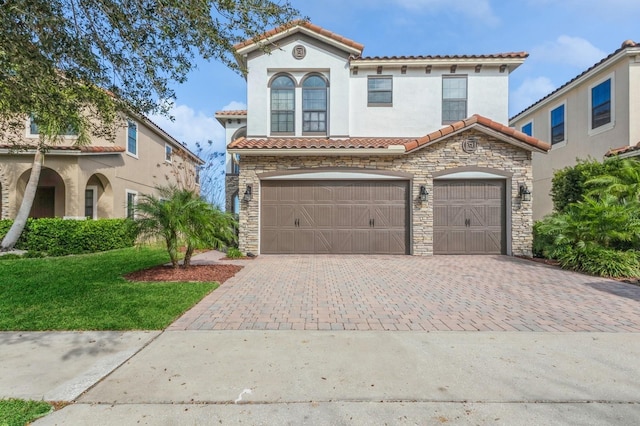 mediterranean / spanish house with a garage