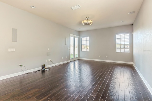 spare room with dark wood-type flooring