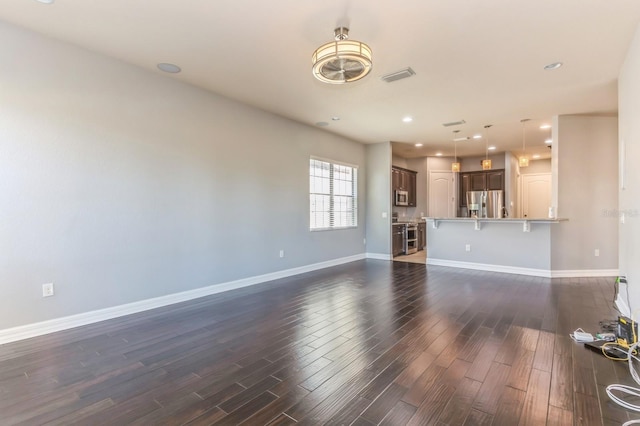 unfurnished living room with dark hardwood / wood-style floors