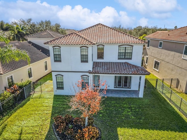 back of property with a yard and a patio area