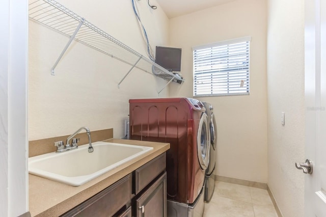 laundry area featuring independent washer and dryer, cabinets, light tile patterned flooring, and sink