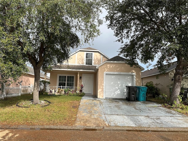 view of property featuring a front yard, covered porch, and a garage