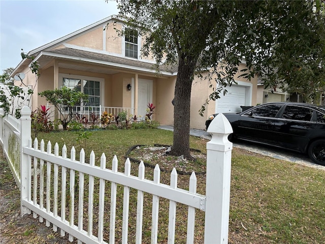 view of front of house with covered porch, a front lawn, and a garage