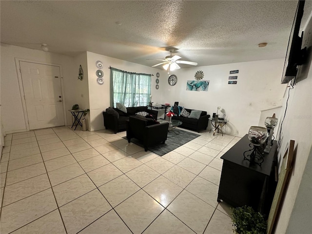 tiled living room featuring a textured ceiling and ceiling fan