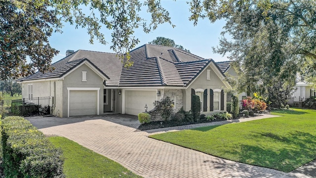 view of front of home with a garage and a front yard