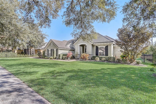 ranch-style home featuring a front yard