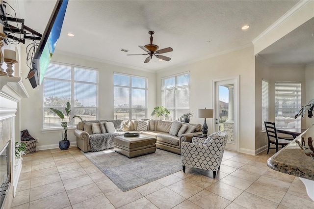 tiled living room with a textured ceiling, ceiling fan, and crown molding