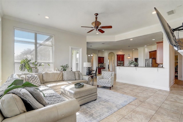 living room with ceiling fan, light tile patterned flooring, and ornamental molding