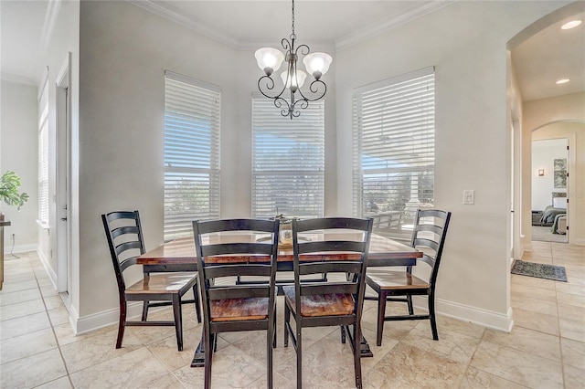 dining area with an inviting chandelier, a wealth of natural light, and crown molding