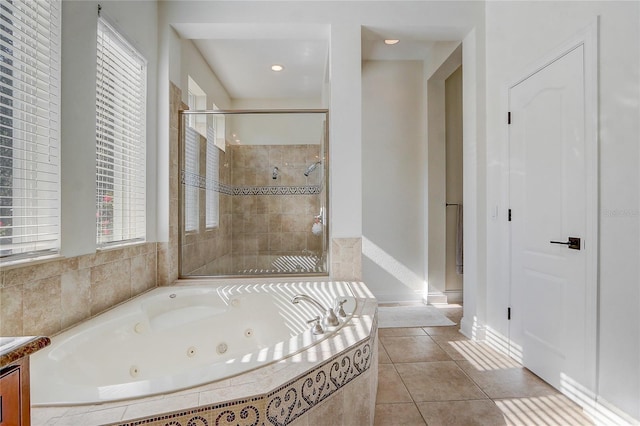 bathroom with tile patterned floors, vanity, and plus walk in shower