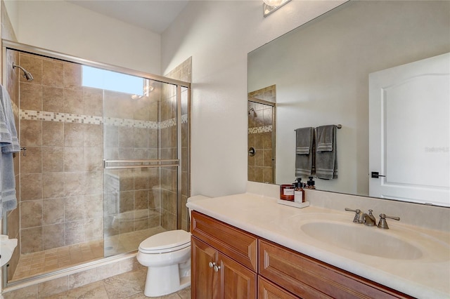 bathroom featuring toilet, vanity, and walk in shower