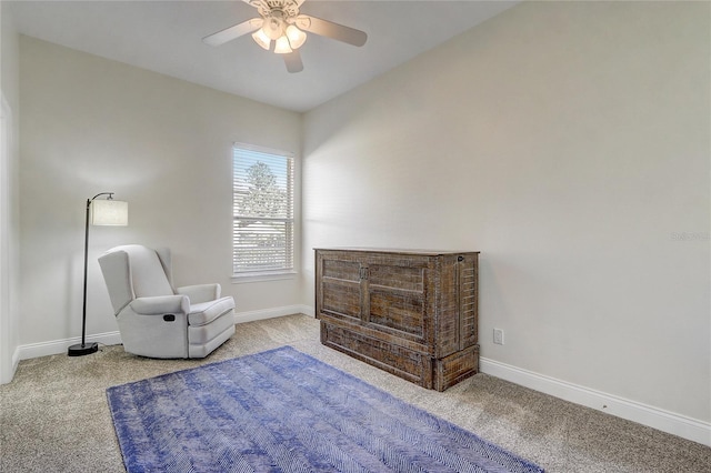 sitting room with ceiling fan and light colored carpet