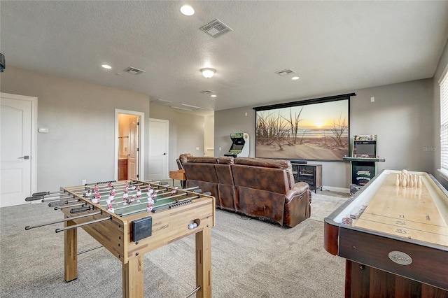 game room featuring light colored carpet and a textured ceiling