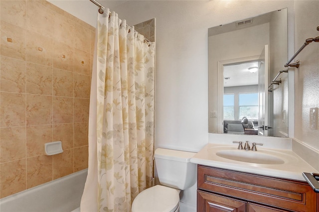 full bathroom featuring toilet, vanity, and shower / bath combo with shower curtain