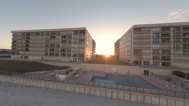 view of pool at dusk