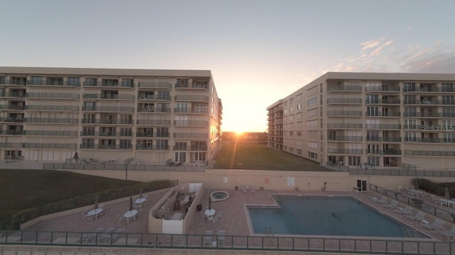 view of pool at dusk