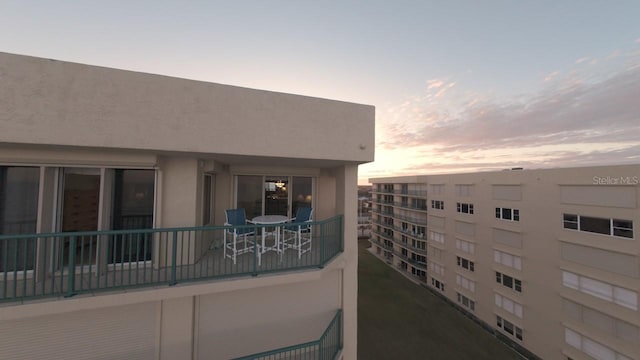 view of balcony at dusk