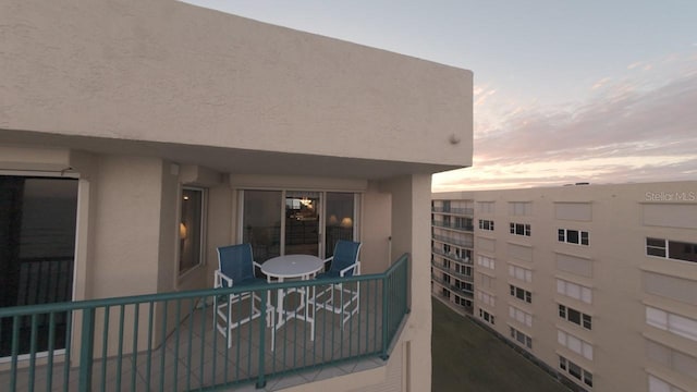 view of balcony at dusk