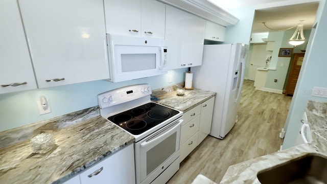 kitchen with white appliances, white cabinetry, sink, hanging light fixtures, and light wood-type flooring