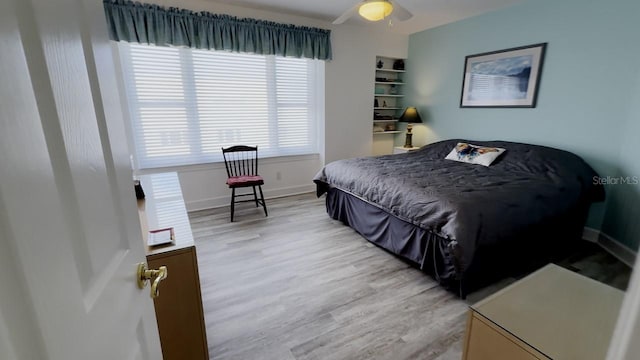 bedroom featuring light wood-type flooring and ceiling fan