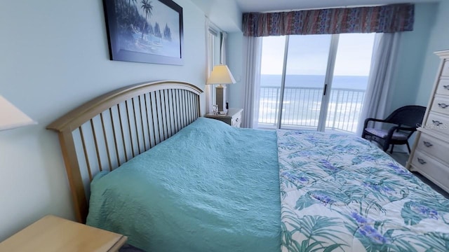 bedroom featuring a water view and access to outside