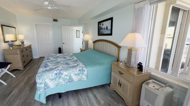 bedroom with ceiling fan, hardwood / wood-style flooring, and multiple windows