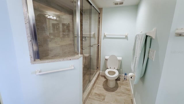 bathroom with toilet and walk in shower