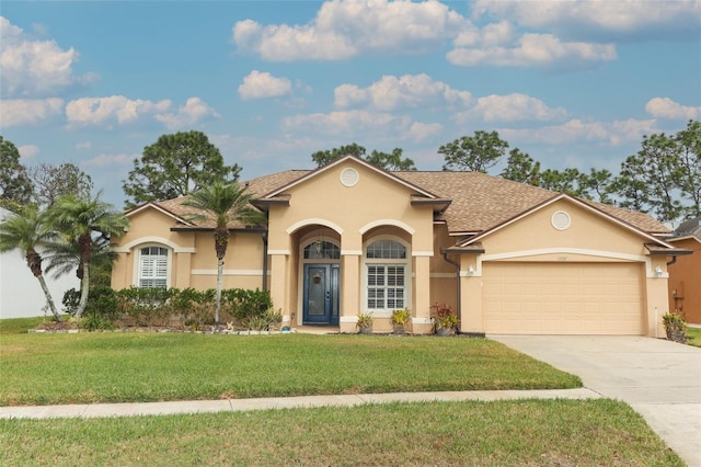 view of front of house with a front lawn and a garage