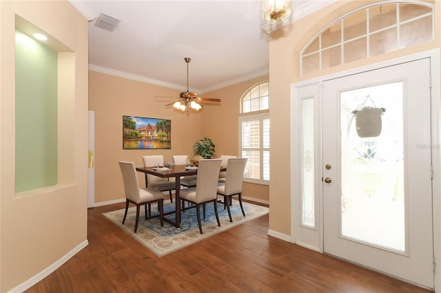 dining area with ornamental molding, ceiling fan, and dark hardwood / wood-style floors