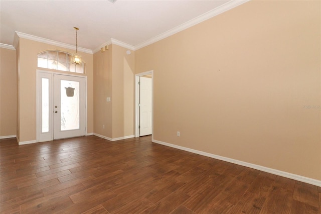 foyer featuring dark hardwood / wood-style flooring, ornamental molding, and a notable chandelier