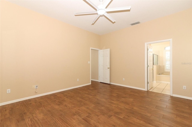 unfurnished bedroom with ceiling fan, wood-type flooring, and connected bathroom