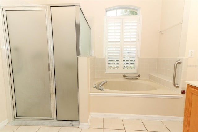 bathroom with tile patterned flooring, separate shower and tub, and vanity