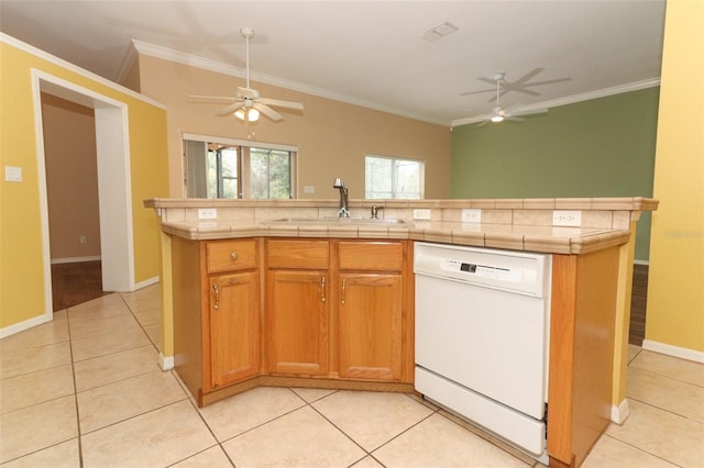 kitchen featuring sink, light tile patterned floors, white dishwasher, a kitchen island, and crown molding