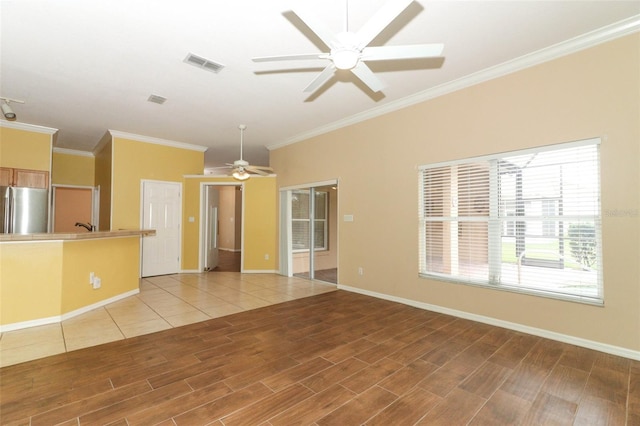 unfurnished living room with ceiling fan and crown molding