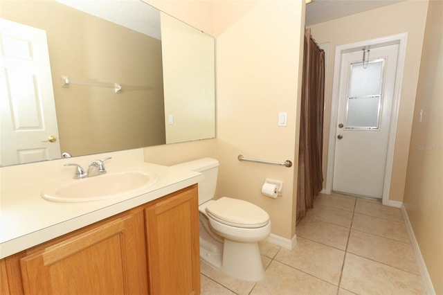 bathroom with toilet, tile patterned flooring, and vanity