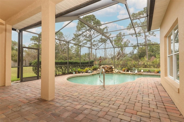 view of pool with a patio and glass enclosure