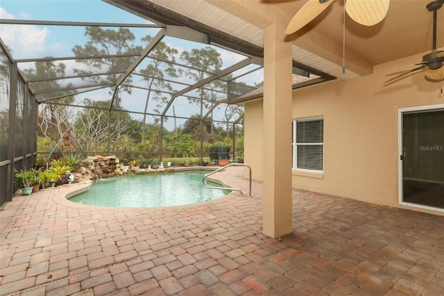 view of pool featuring a lanai, ceiling fan, and a patio area