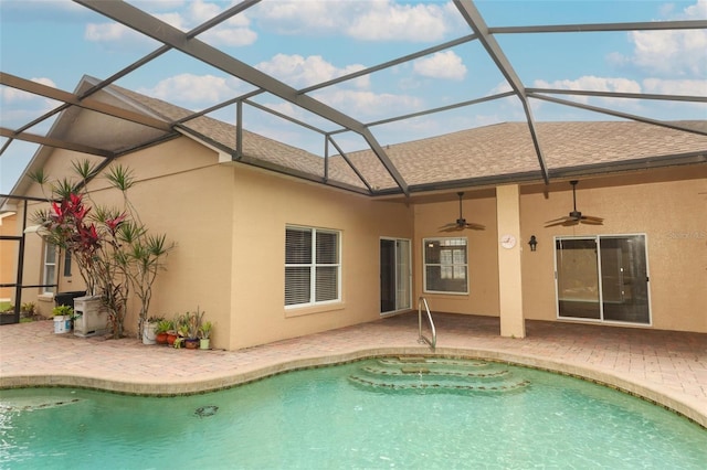 view of pool featuring ceiling fan, glass enclosure, and a patio