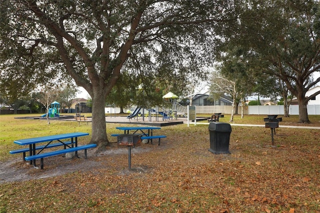 view of home's community featuring a yard and a playground