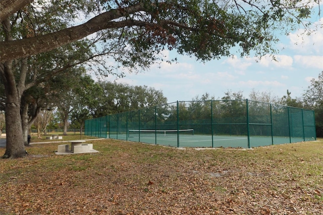 view of sport court featuring a lawn